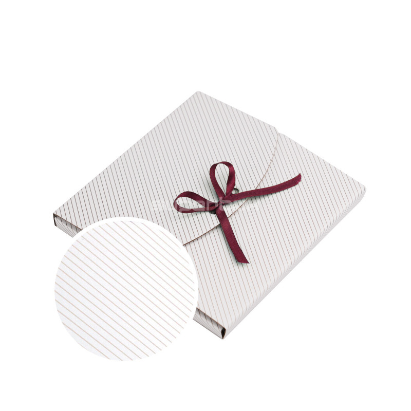 Small White Envelope with Gold Lines Tied With a Ribbon